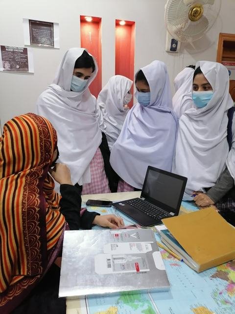 Students studying together on a laptop