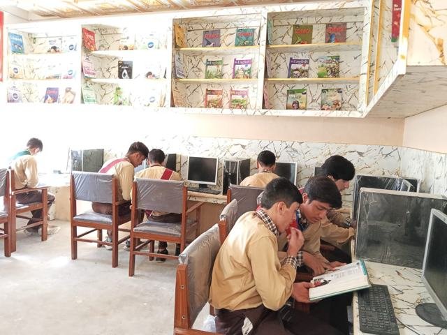 Schoolboys use the new computers