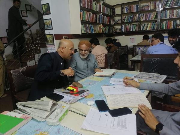 Prof. Dr. Lal Khan Kakar with a reader at the library